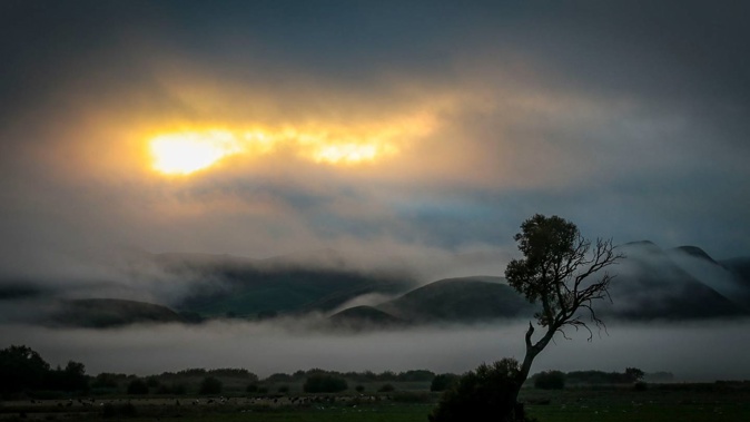 The early morning sun, pictured from Poukawa, south of Hastings, grabs an opportunity on Saturday, but had to yield to the clouds for much of the weekend. Photo / Paul Taylor.