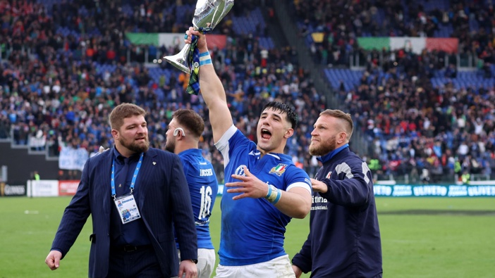 Tommaso Menencello of Italy celebrates with the Cuttitta Cup following the team's victory during the Guinness Six Nations 2024 match between Italy and Scotland at Stadio Olimpico on March 09, 2024 in Rome, Italy. (Photo by Giampiero Sposito/Getty Images)