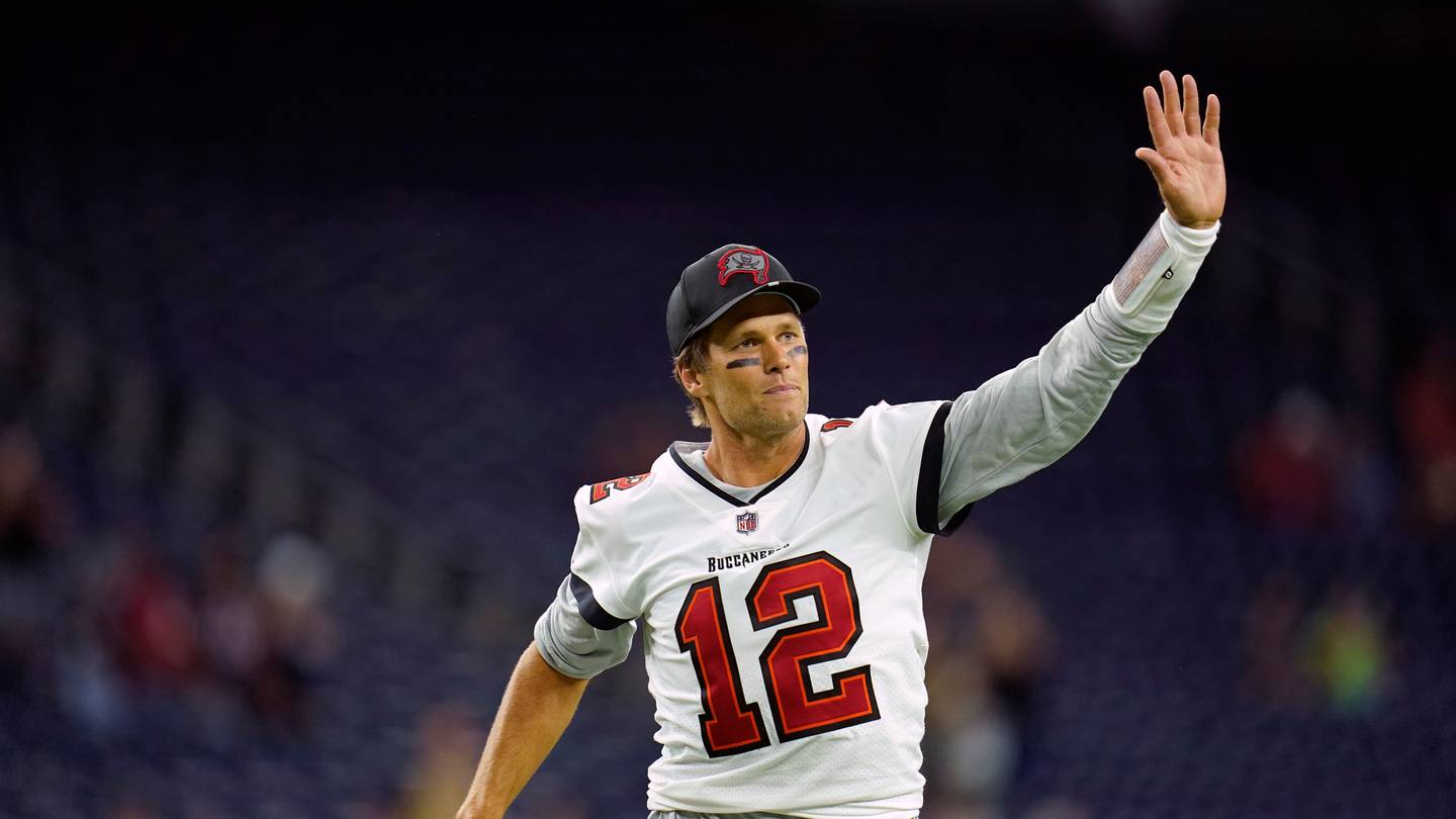 Tampa Bay Buccaneers quarterback Tom Brady waves toward the fans as he leaves the field after an NFL preseason game. (Photo / AP)