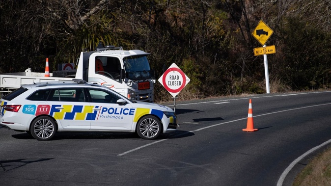 The police cordon at the intersection of Te Anga and Waipuna roads, where Tom Phillips shot at officers then was fatally shot earlier this week. Photo / Hayden Woodward