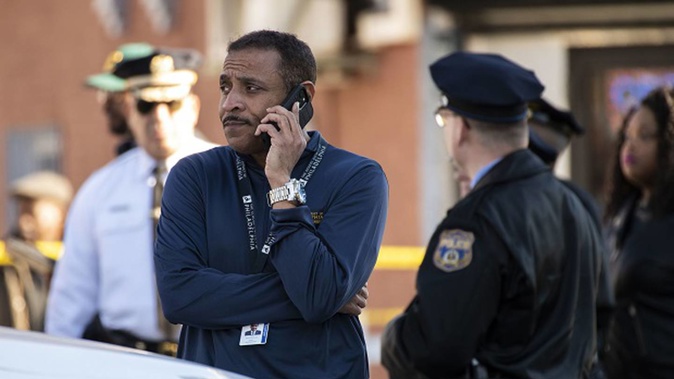 Philadelphia schools superintendent Tony Watlington talks on the phone after a shooting. Photo / AP