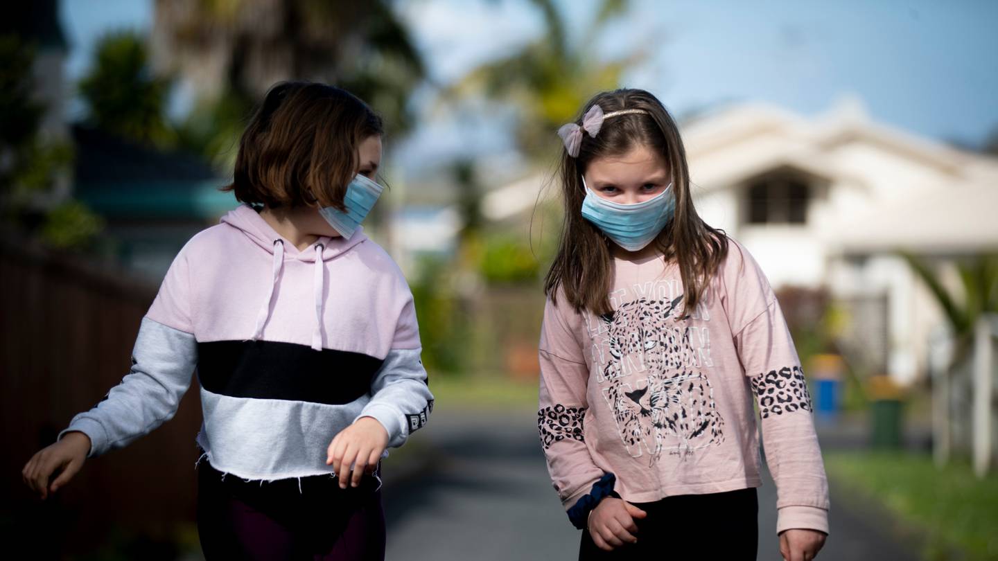 Megan Purcell, 8, and Zara Nicholas, 8, wearing their Covid-19 masks as they go for a walk. Photo / Dean Purcell.