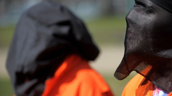 People dressed as 'torture detainees' participate in a rally sponsored by a group called the Washington Religious Campaign To Stop Torture on March 10, 2008 (Getty Images)