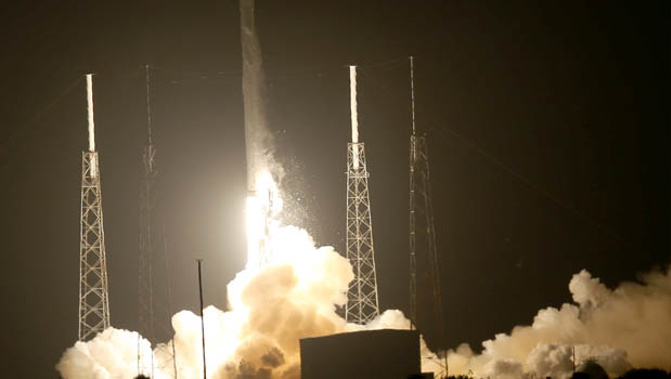 SpaceX aims to launch a new era in modern rocket science by landing a key part of its Falcon 9 rocket on a barge in the Atlantic Ocean. (Getty Images)