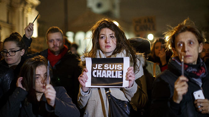 A woman holds up a Je Suis Charlie sign in support of the attacked satirical newspaper Charlie Hebdo (Getty Images)