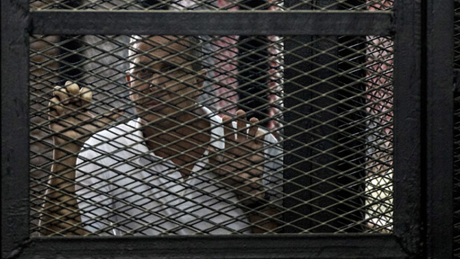 Al-Jazeera journalist Peter Greste inside the defendants cage during his 2014 trial. (Getty Images)