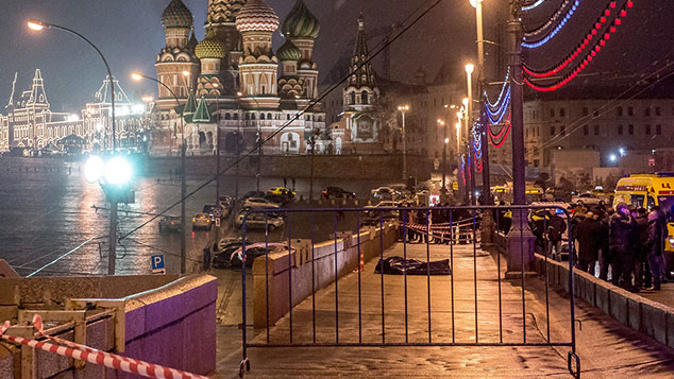 The body of killed Russian opposition leader and former Deputy Prime Minister Boris Nemtsov, covered by plastic, seen on Bolshoi Moskvoretsky bridge near St. Basil cathedral (Getty Images) 