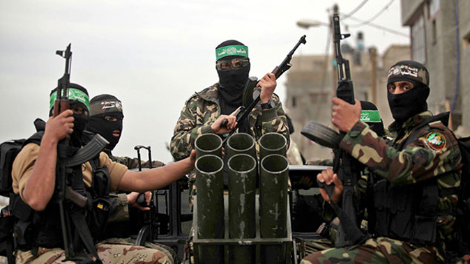 Palestinian youths who attend a military style training camp of Ezzedin al-Qassam Brigades, the armed wing of Hamas movement, take part in a military parade in Gaza (Getty Images)