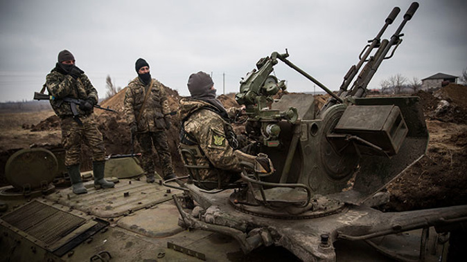 Ukrainian soldiers stand on top of an armored personal carrier in a newly dug trench near the front line of defense against pro-Russian seperatists (Getty Images) 