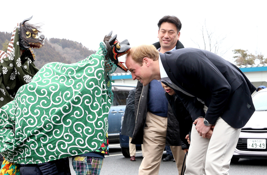 Prince William, Duke of Cambridge is greeted by Lion Dancers performing in an Shishimai Ceremony at Chime of Hope Shopping Centre in Japan.