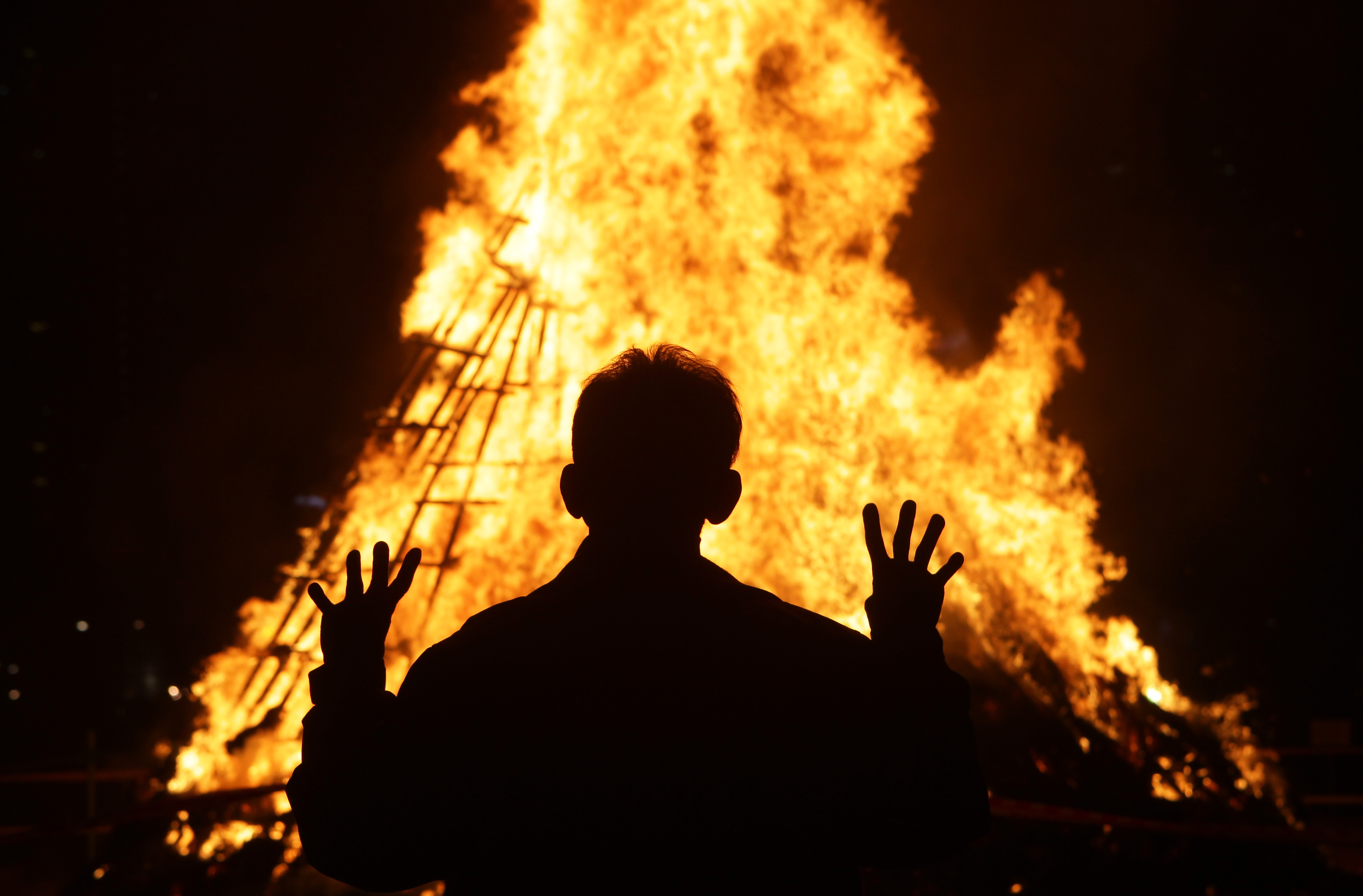 South Koreans gather around a bonfire during 'Jwibulnoli' a South Korean folk game.