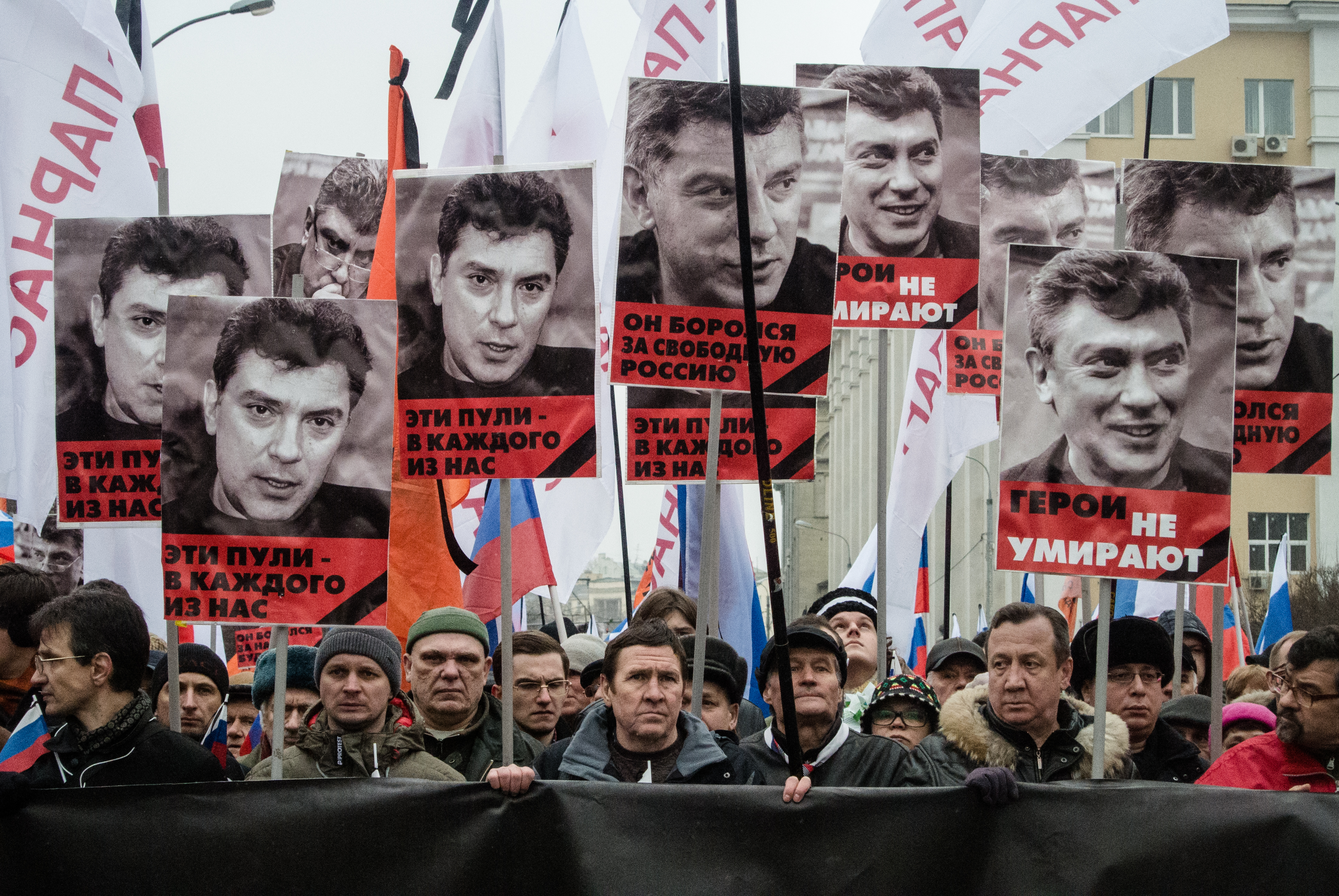 People hold up portraits of Russian opposition leader Boris Nemtsov as they march in memory of him on March 01, 2015 in Saint-Petesrburg, Russia.