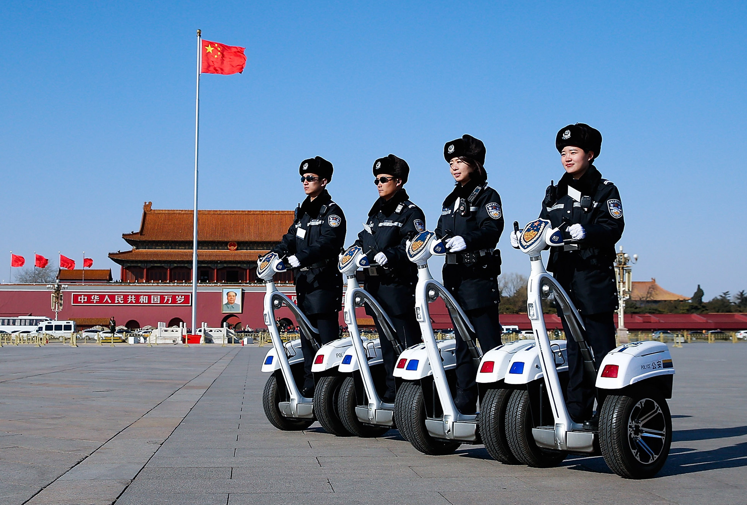 Police officers on motorized vehicles patrol at Tiananmen Square during the opening session of the Chinese People's Political Consultative Conference (CPPCC) on March 3, 2015 in Beijing, China. 