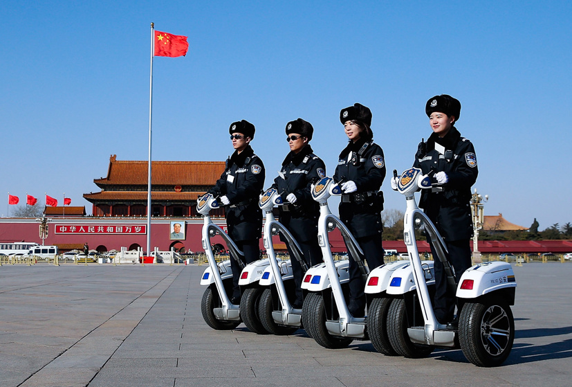 Police officers on motorized vehicles patrol at Tiananmen Square during the opening session of the Chinese People's Political Consultative Conference (CPPCC) on March 3, 2015 in Beijing, China.