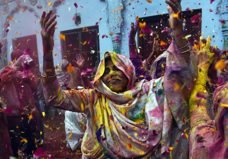 Indian widows dance as they celebrate Holi or 'festival of colors' in Vrindavan on March 3, 2015.