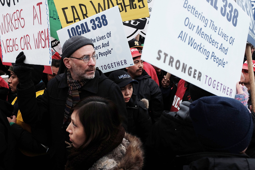 Workers and supporters stand in front of the Vegas Auto Spa, a car wash that has become a focal point for labor and union rights, during a rally on March 4, 2015 in the Brooklyn borough of New York City.