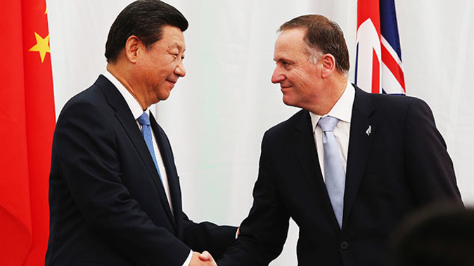 Pesident Xi Jinping shakes hands with New Zealand Prime Minister John Key, November 2014 (Getty Images)