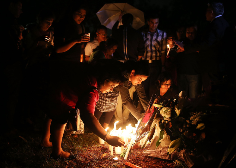 People gather to lay flowers at a memorial site for victim Prabha Arun Kumar on March 11, 2015 in Sydney, Australia. The fatal stabbing of Prabha Arun Kumar in a Parramatta park last Saturday sparked community and international outrage. 