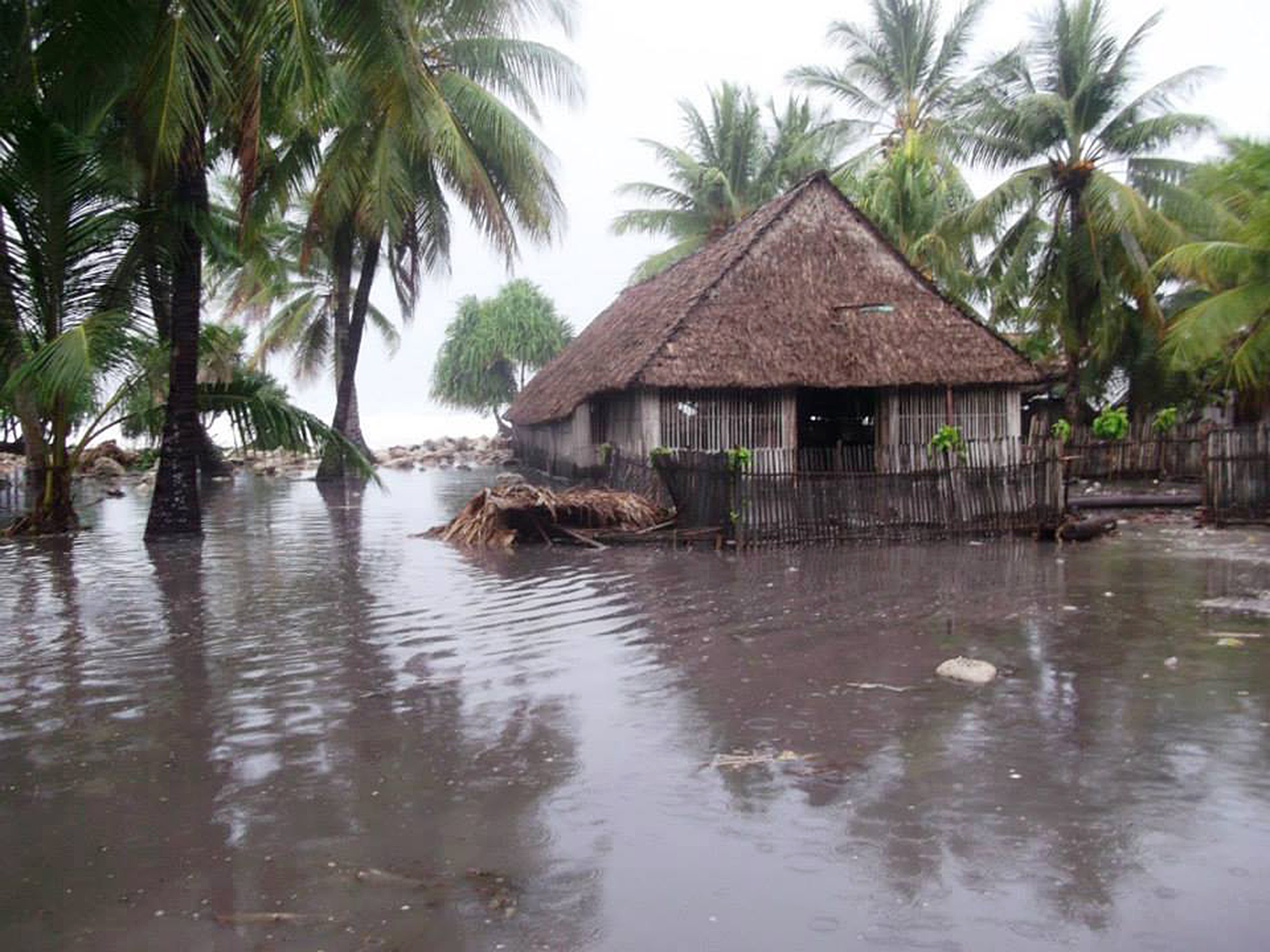 Floodwaters surround a house in Kiribati.