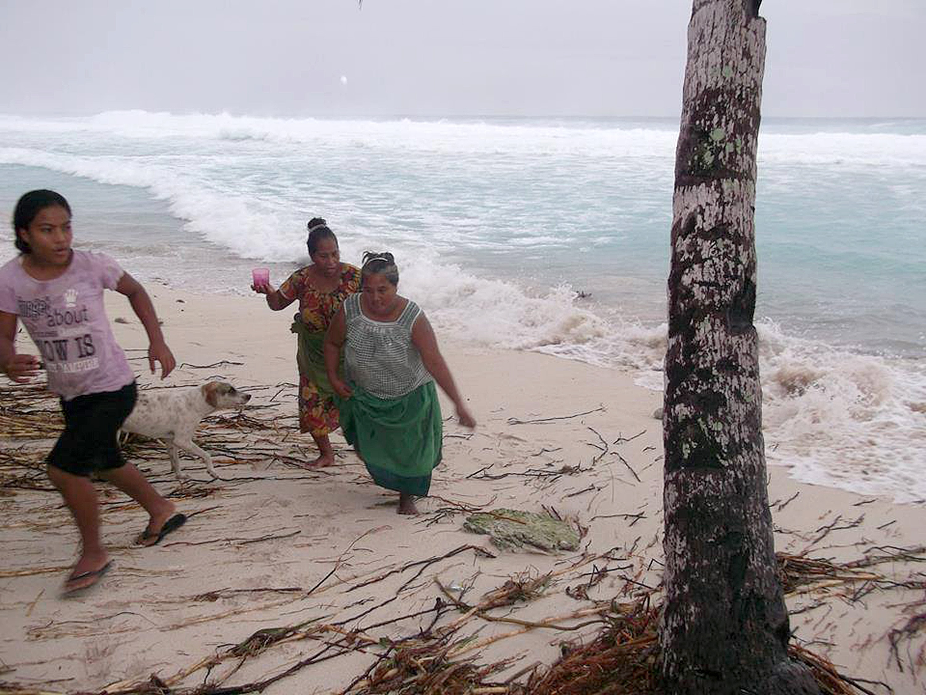 People move away from the beach in Kiribati.