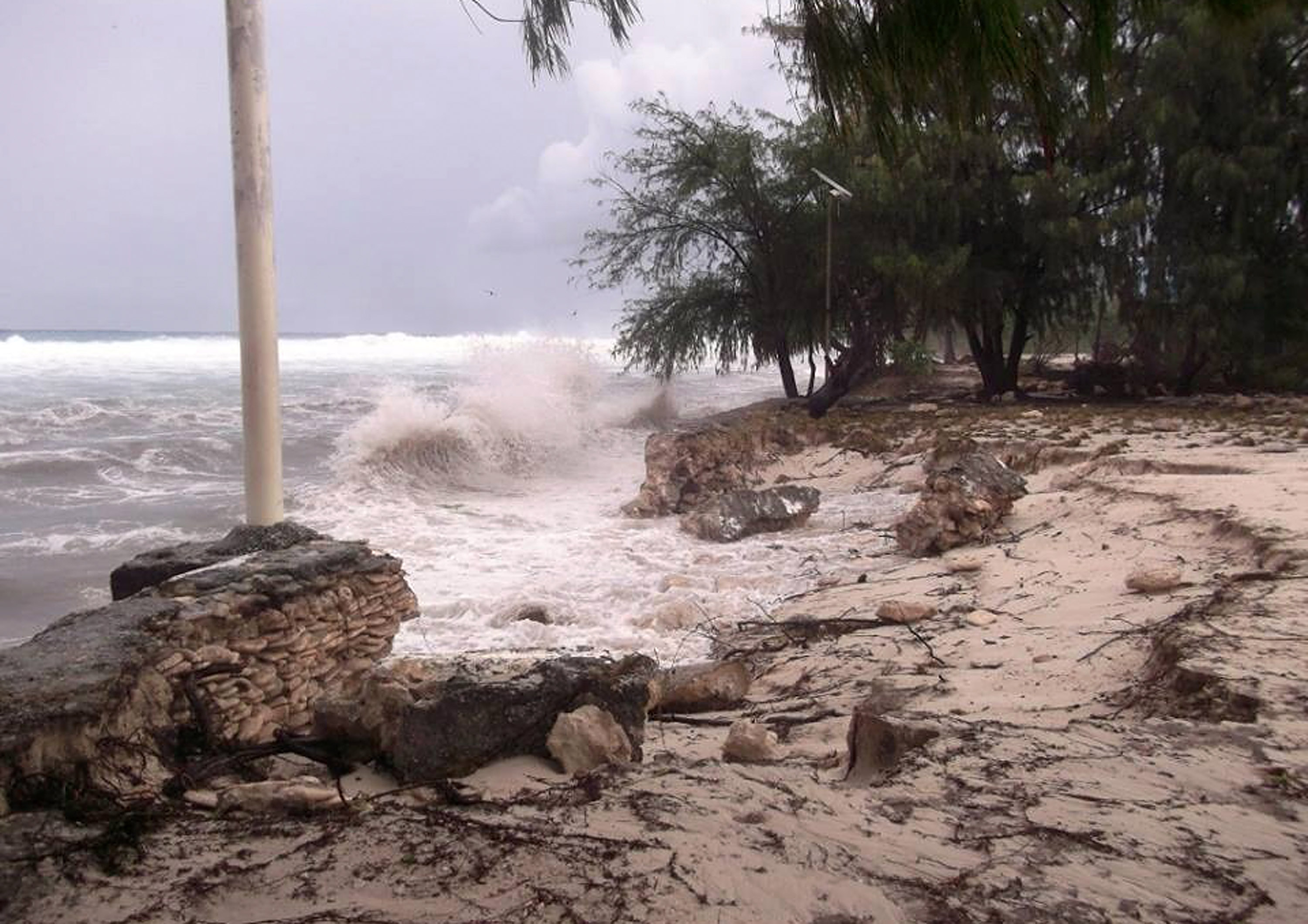 Debris batters a beach in Kiribati.
