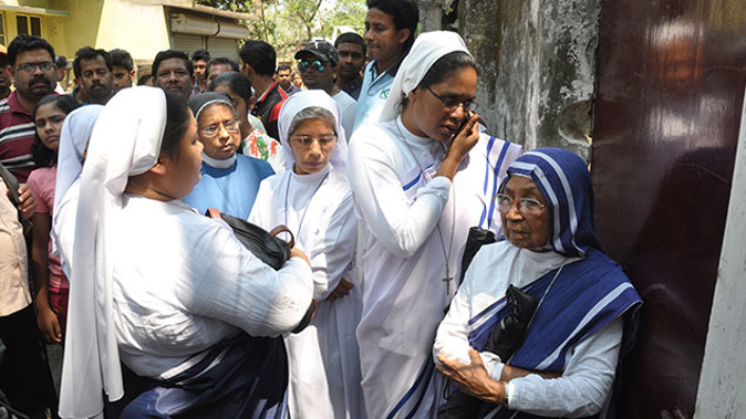 Christians nuns stand next to the Convent of Jesus and Mary in Ranaghat, 70 kilometres north of Kolkata, as investigations continued into the gang-rape of a 71-year-old nun at the convent. (Getty Images) 