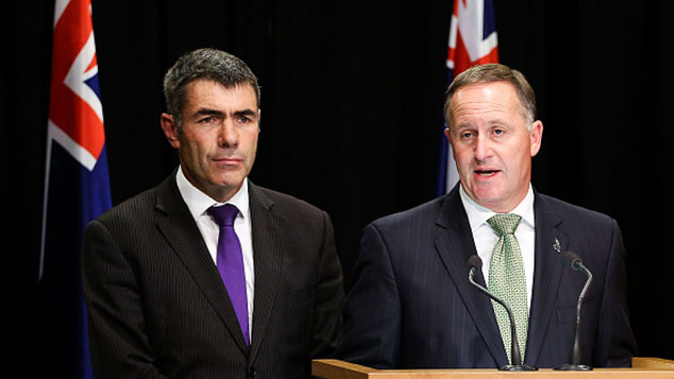 John Key talks to the media while Minister for Primary Industries Nathan Guy looks on (Getty Images) 