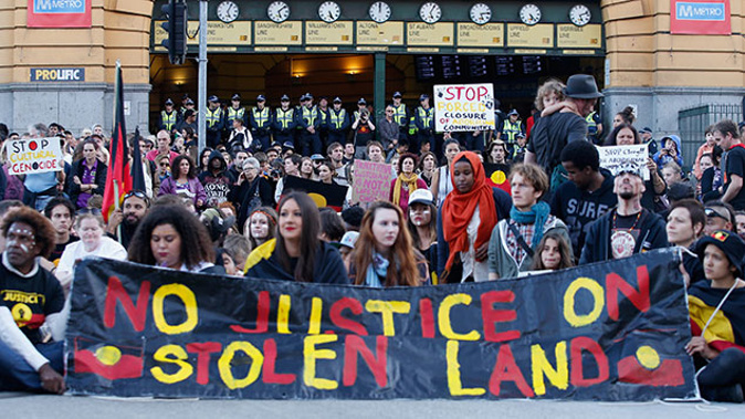 Demonstrators protest at the intersection of Swanston and Flinders street on April 10, 2015 in Melbourne, Australia (Getty Images)