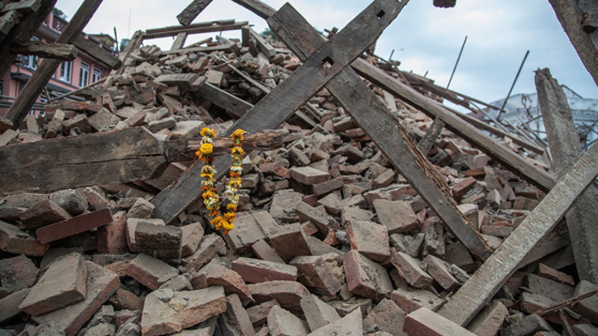 Flowers left on the debris of a destroyed building in Kathmandu (Getty Images)