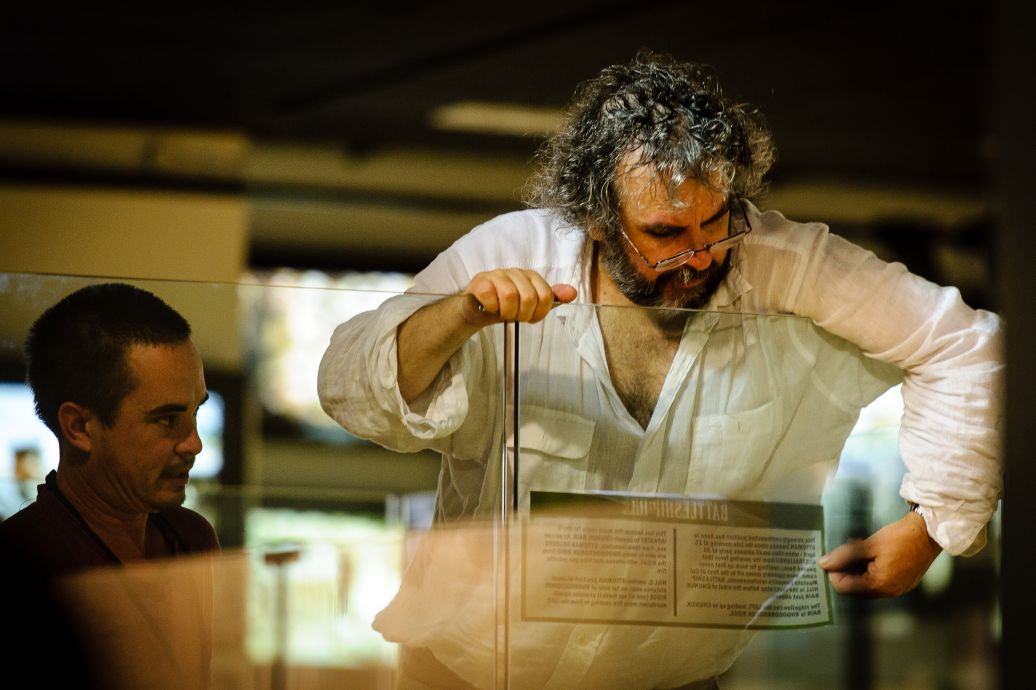 Sir Peter Jackson helps put the fishing touches on the new part of the exhibition. WELLINGTON, NEW ZEALAND - May 04: Opening of "Gallipoli: the New Zealand Story in Colour"  Great War Exhibition, Pukeahu National War Memorial, Buckle St, Wellington May 04, 2015 in Wellington, New Zealand. (Photo by Mark Tantrum/ mark tantrum.com)
