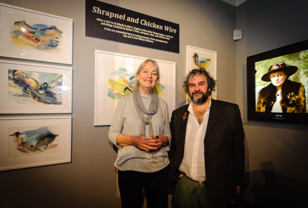 Artist Anita Young with Sir Peter Jackson in front of Anita's work and a portrait of her Grandmother. WELLINGTON, NEW ZEALAND - May 04: Opening of "Gallipoli: the New Zealand Story in Colour"  Great War Exhibition, Pukeahu National War Memorial, Buckle St, Wellington May 04, 2015 in Wellington, New Zealand. (Photo by Mark Tantrum/ mark tantrum.com)