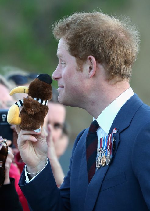 Prince Harry is given a toy kiwi as he meets members of the public outside the National War Memorial. Photo / Getty Images)