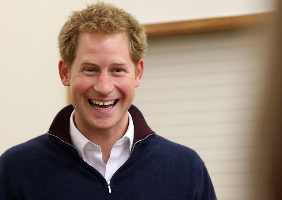 Prince Harry laughs as he attempts to open a Bluff oyster at the Stewart Island Community Centre / Photo: Getty Images