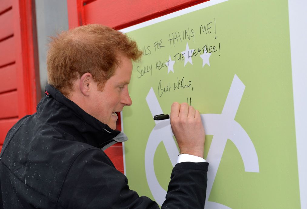 Prince Harry signs his name on a shed during a visit to the University of Canterbury in Christchurch / Photo:  Owen Humphreys/PA Wire
