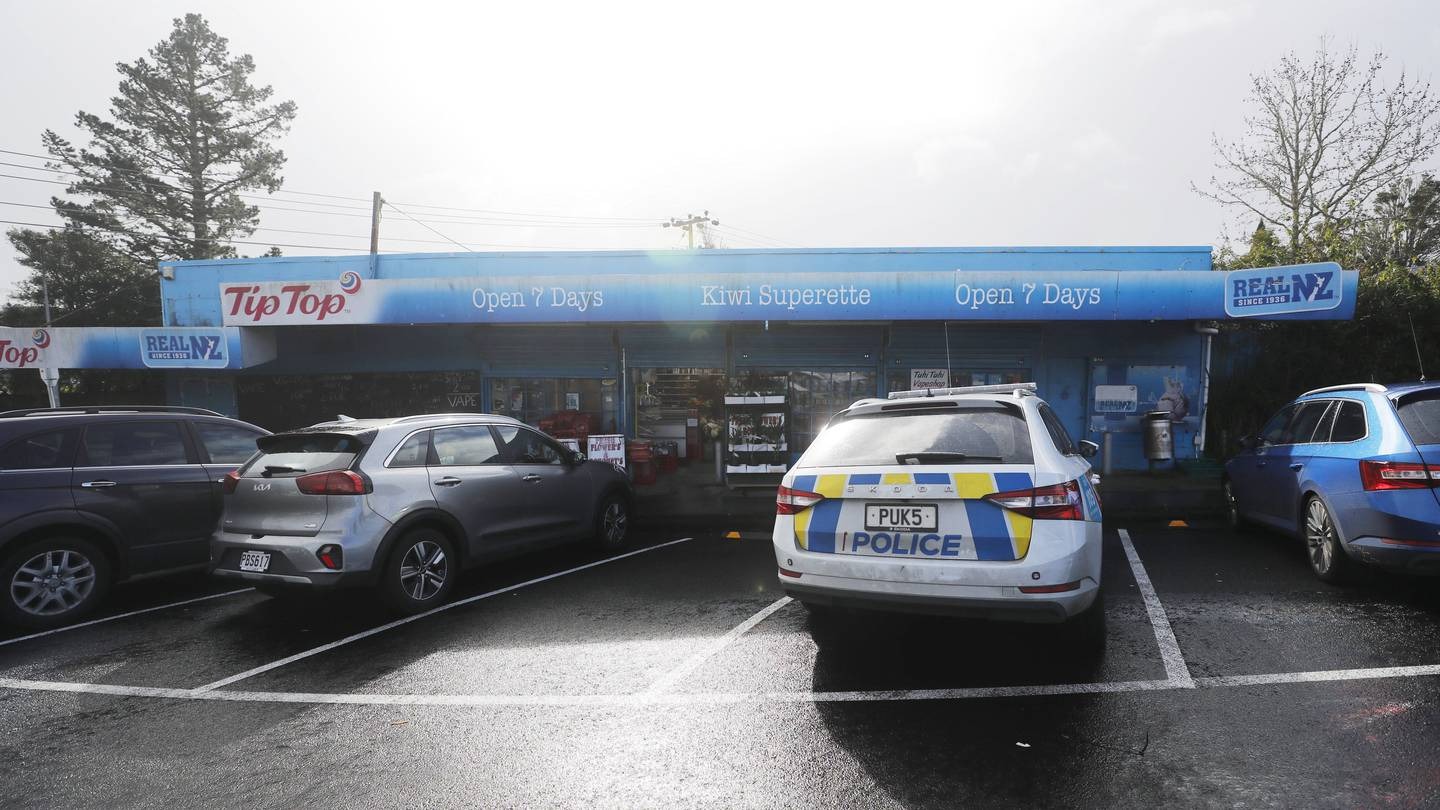 Police cars outside the Kiwi Superette after the robbery. Photo / Dean Purcell