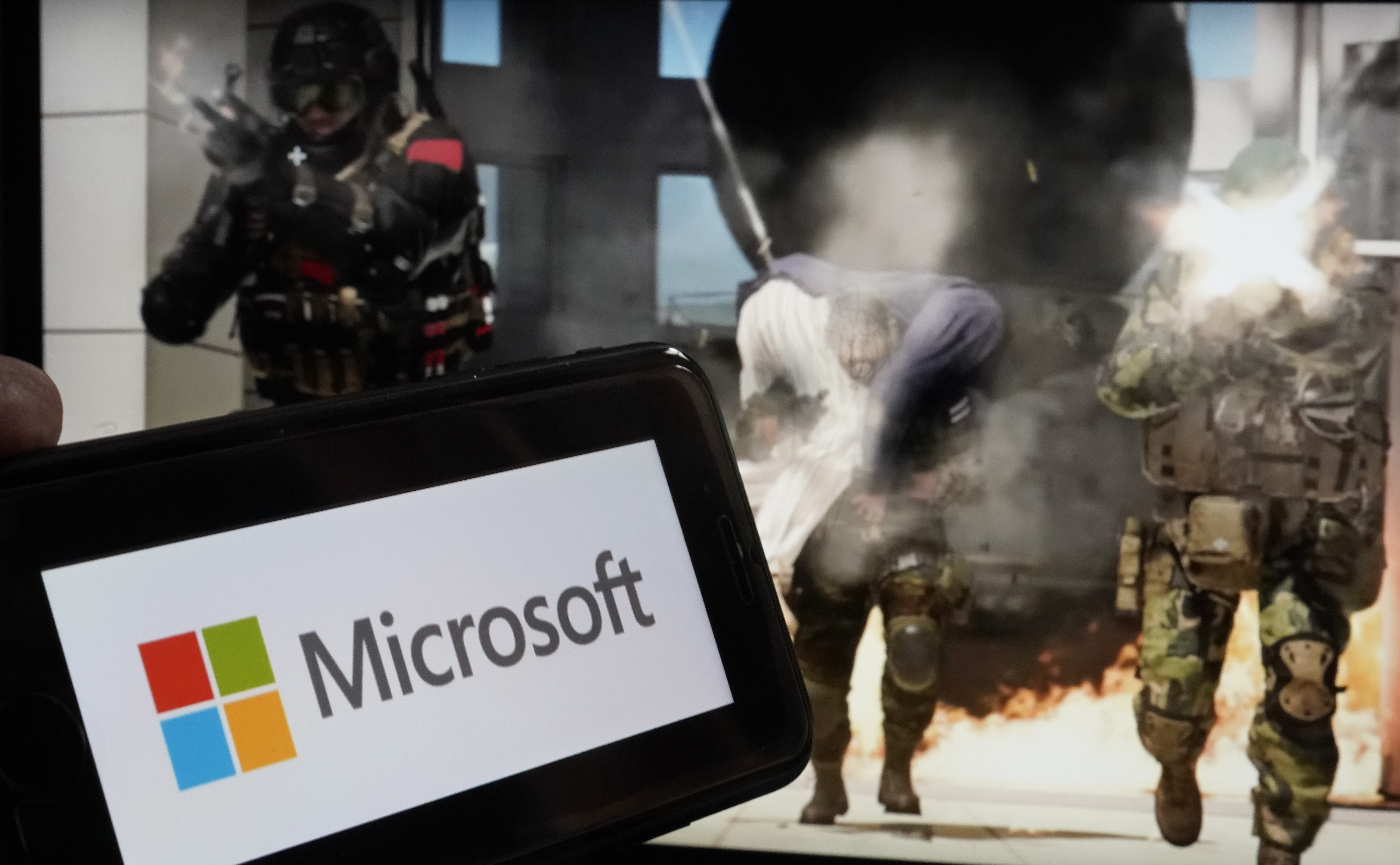 The logo for Microsoft, and a scene from Activision "Call of Duty - Modern Warfare," are shown in this photo, in New York, Wednesday, June 21, 2023. Photo / AP