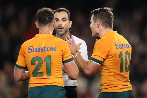 Nic White and Bernard Foley plead their case with referee Mathieu Raynal. Photo / Getty