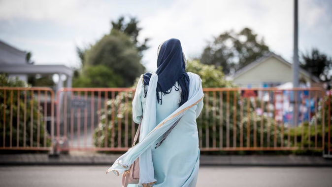 A mourner outside the Linwood Islamic Centre a week after the Christchurch terror attacks. Photo / Michael Craig