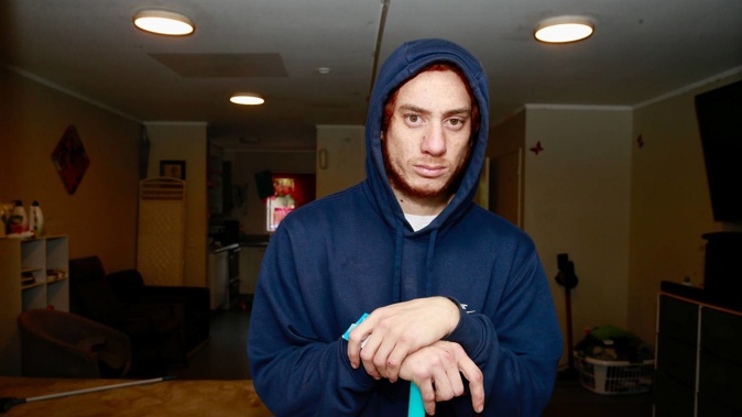 Te Aho Witehira cleaning his sister’s house in Otahuhu following a violent home invasion this morning. New Zealand Herald photograph by Alex Burton