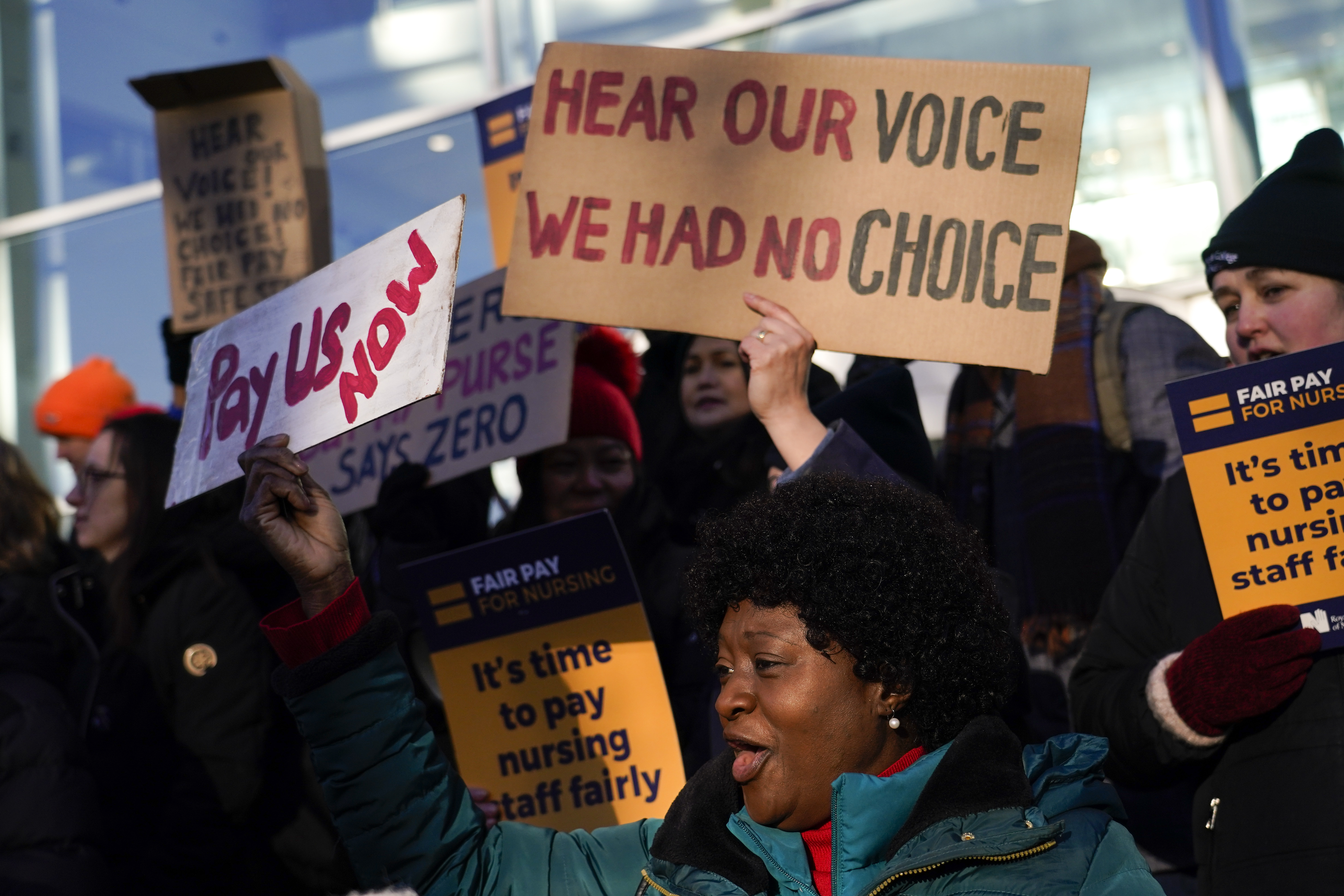 Nurses hold banners and placards as they picket during a strike over pay, outside the University College Hospital, in London. Photo / AP