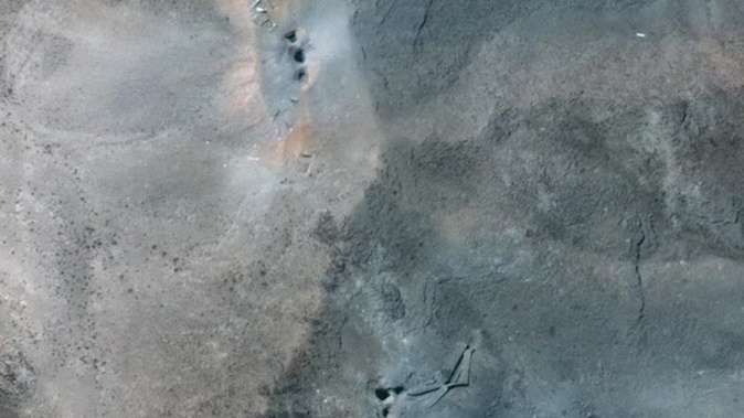 A satellite photo by Maxar Technologies, shows craters and ash on the ridge at the Fordow underground complex in Iran after US strikes. Photo / Maxar Technologies