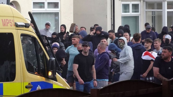 Riot police hold back protesters after disorder broke out on in Southport, England. Photo / Getty Images