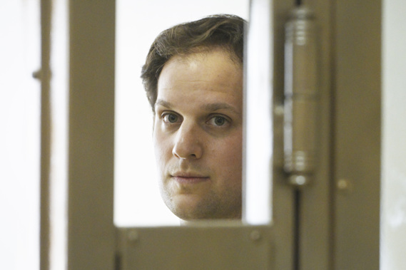 Wall Street Journal reporter Evan Gershkovich stands in a glass cage in a courtroom at the Moscow City Court. Photo / AP