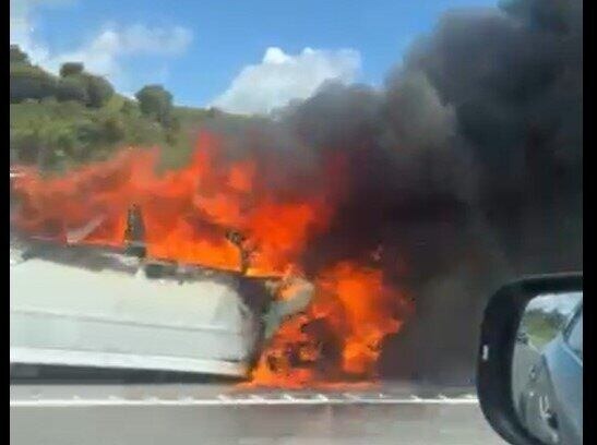 Flames and smoke pour from car on SH29