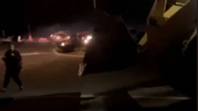 The loader is driven towards a group of boy racers on Mahuta Station Rd on Friday night. (Photo / rfbdaily)