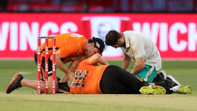 Matthew Kelly of the Scorchers lies on the ground after being struck in the face with the ball. Photo / Getty