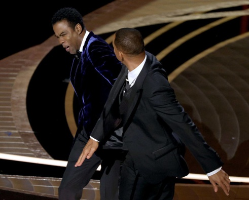 Chris Rock appears to be struck by Will Smith on stage. (Photo / Getty Images)