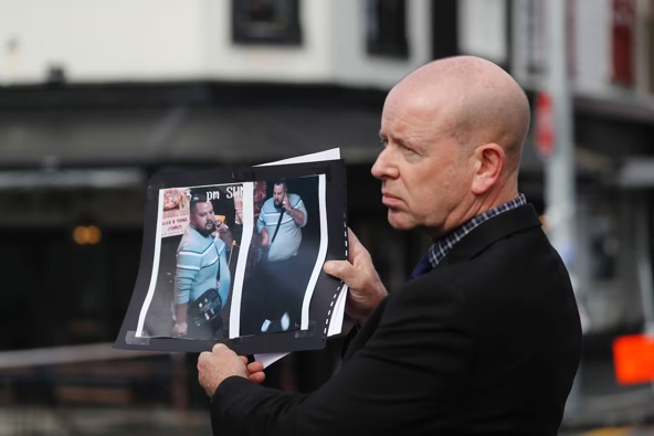 Detective Inspector Chris Barry shows images of the suspect wanted in relation to the shooting on Ponsonby Rd last night. Photo / Dean Purcell
