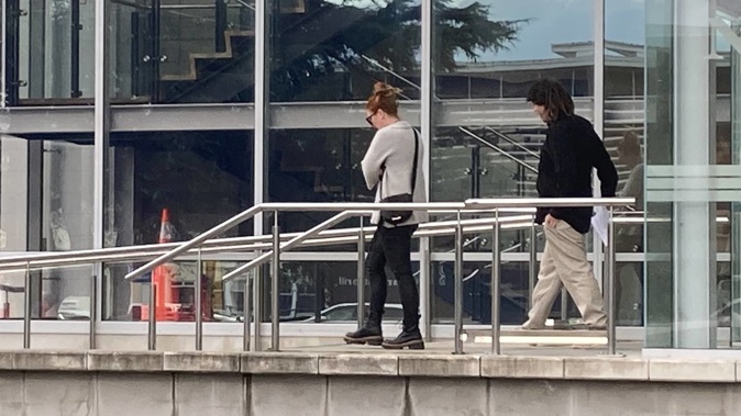 Jordan Turner-Critchley behind a supporter as they left the Nelson District Court today. Photo / Tracy Neal