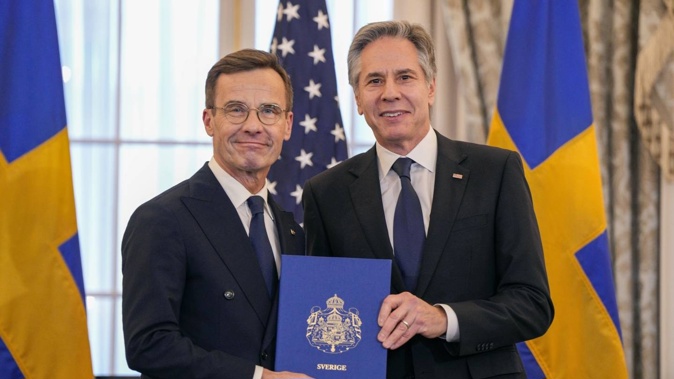 Secretary of State Antony Blinken (right), with Swedish Prime Minister Ulf Kristersson holding Sweden's Nato Instruments of Accession at the State Department. Photo / AP